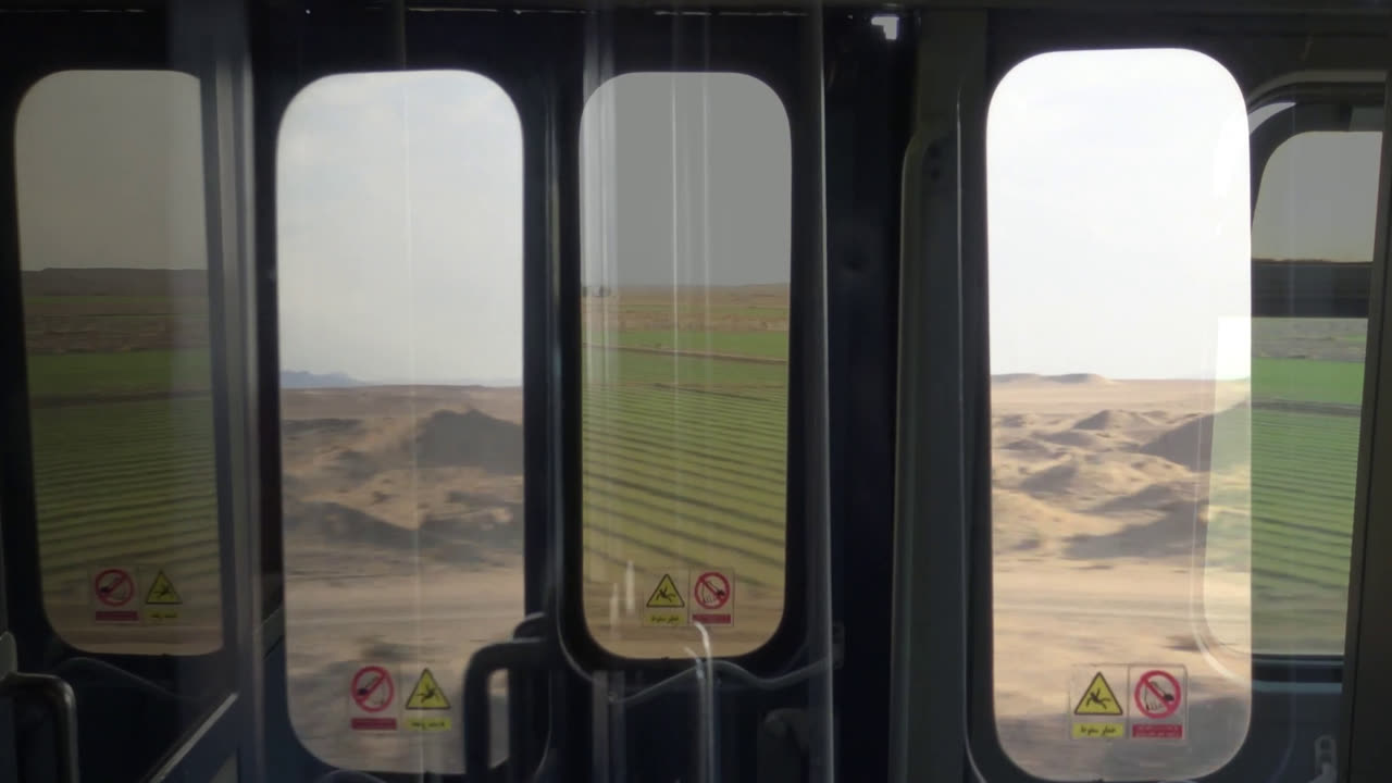 Desert landscape seen through the windows of a train